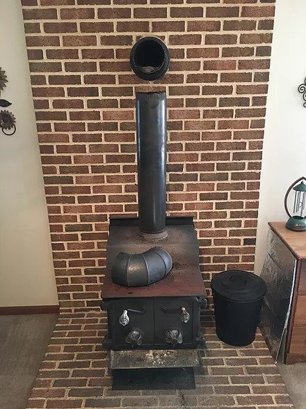 dirty black stove with open pipe