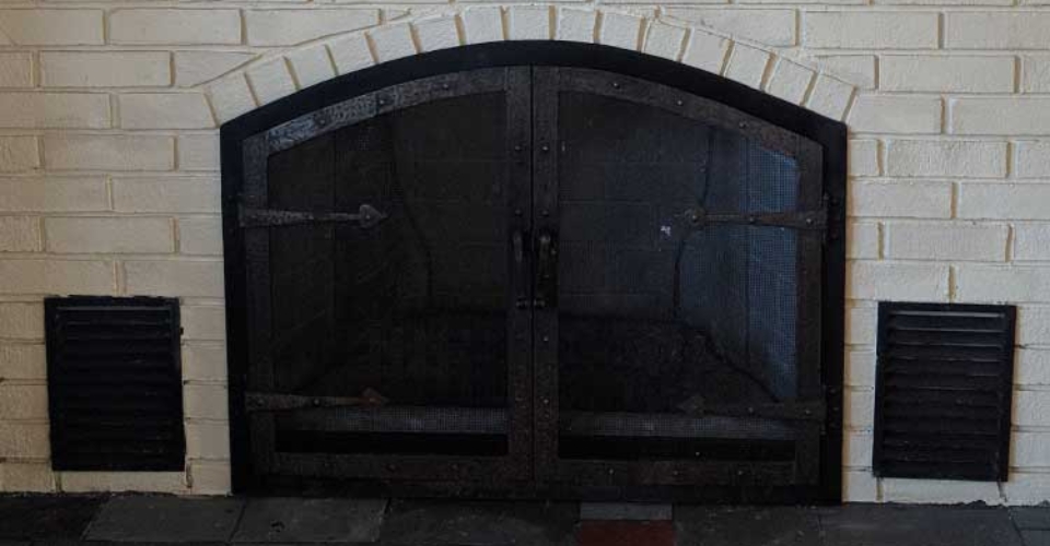 black fireplace with screen doors