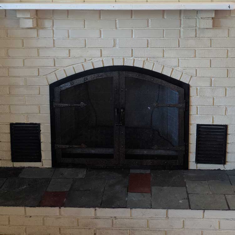 black fireplace with screen doors