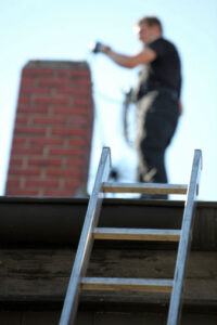 man sweeping chimney